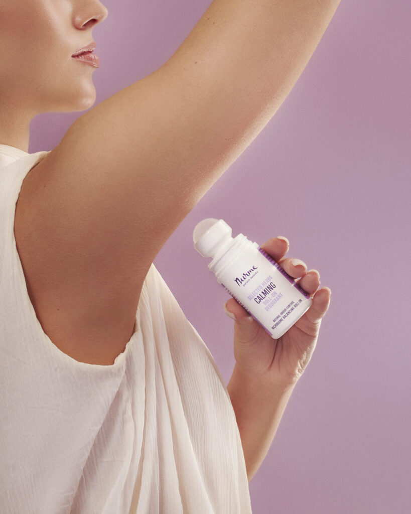 Woman holding Nurme Selected Herbs roll-on deodorant