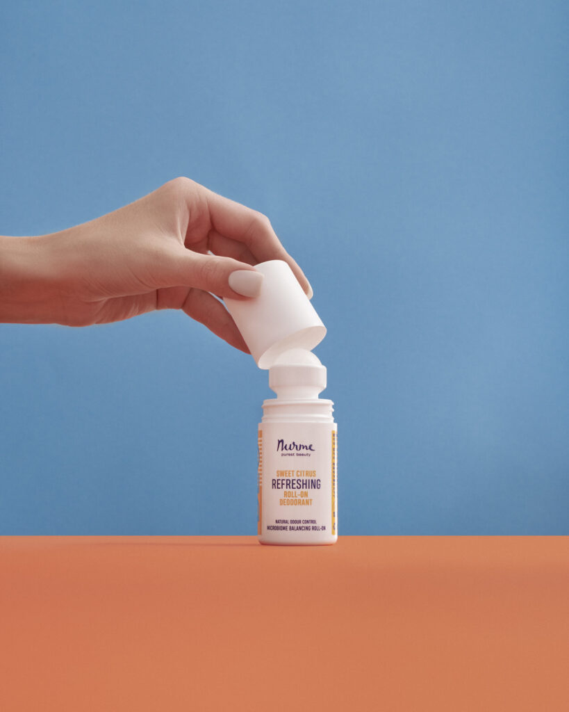 Nurme Sweet Citrus roll-on deodorant with the cap lifted off
